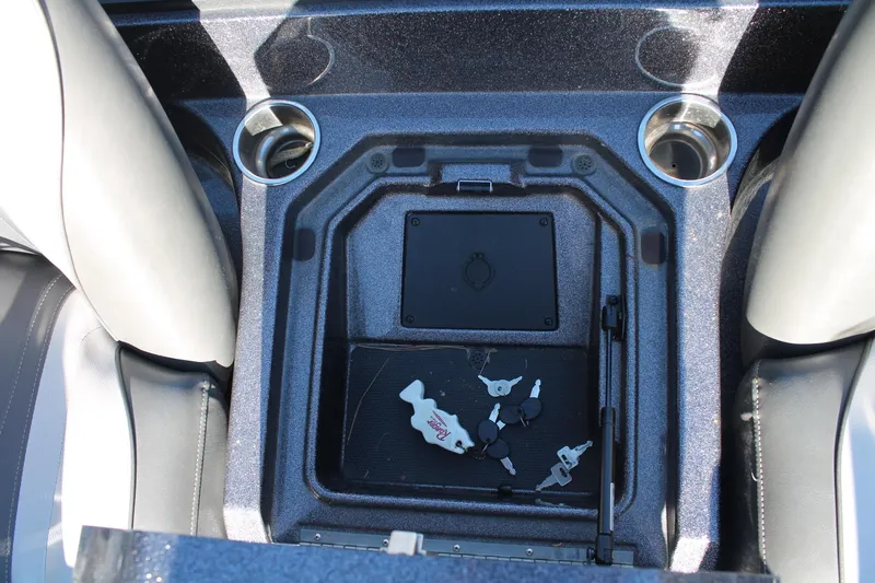 Slide: The Image of 2020 Ranger Z521L boat console with cup holders and keys. - 14