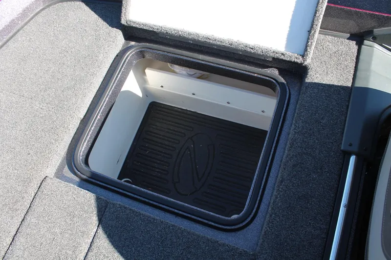 Slide: The Image of 2020 Ranger Z521L boat storage compartment with open lid, featuring carpeted interior. - 17