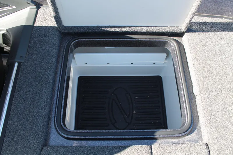 Slide: The Image of 2020 Ranger Z521L boat storage compartment with open lid, featuring a black interior mat. - 18