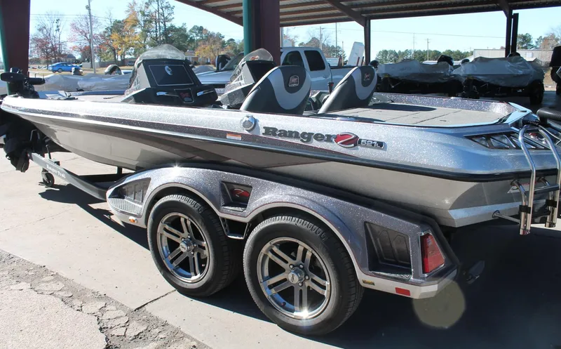 Slide: The Image of 2020 Ranger Z521L boat on trailer, parked outdoors under a canopy. - 22