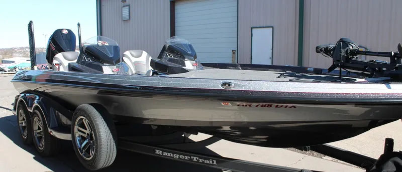 Slide: The Image of 2020 Ranger Z521L bass boat on trailer, parked outside a building. - 24