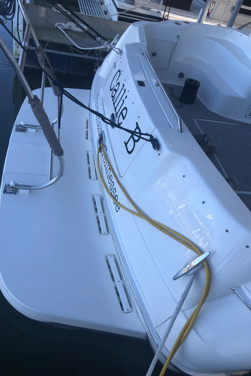 Slide: The Image of 2001 Sea Ray 400 Sedan Bridge yacht docked, rear view with name "Callie B". - 14