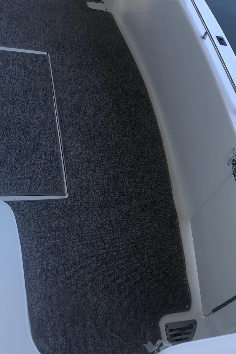 Slide: The Image of 2001 Sea Ray 400 Sedan Bridge interior with gray carpet flooring. - 17