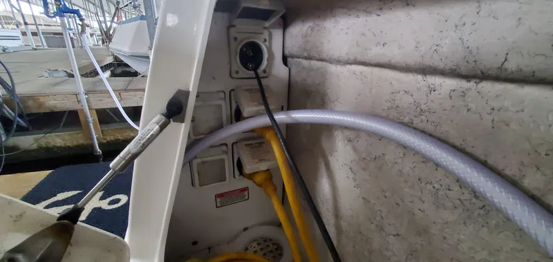 Slide: The Image of 2001 Sea Ray 400 Sedan Bridge electrical and hose connections at dock. - 28