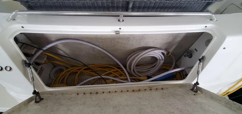 Slide: The Image of Storage compartment with cables on a 2001 Sea Ray 400 Sedan Bridge. - 30