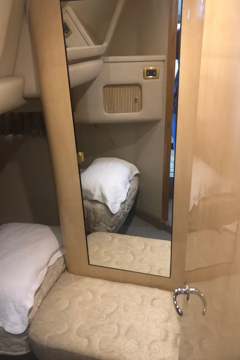 Slide: The Image of Interior cabin of 2001 Sea Ray 400 Sedan Bridge with mirror and bedding. - 44