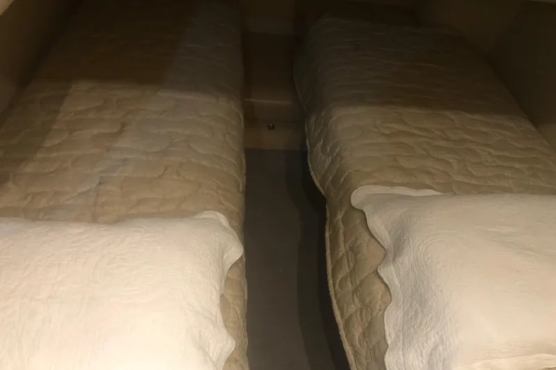 Slide: The Image of Twin beds in 2001 Sea Ray 400 Sedan Bridge cabin, beige bedding. - 45