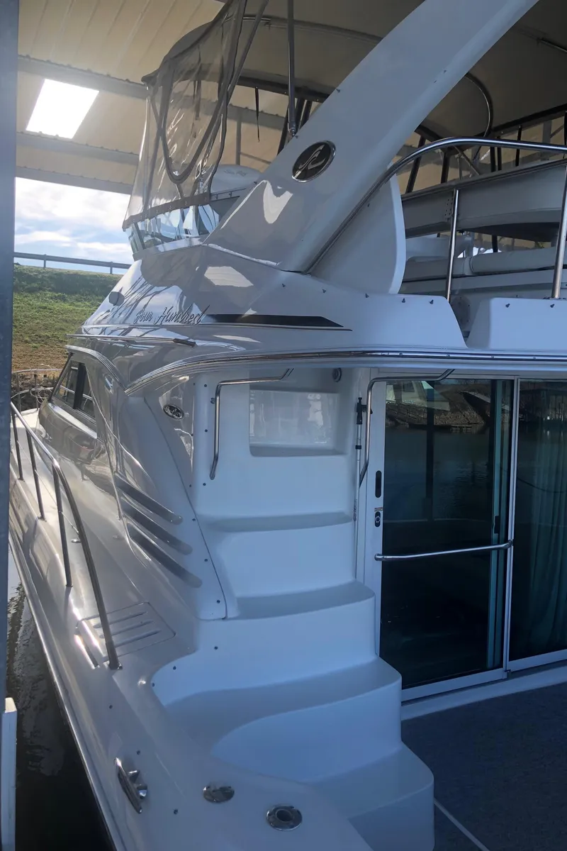 Slide: The Image of 2001 Sea Ray 400 Sedan Bridge yacht with sleek white exterior and upper deck. - 8