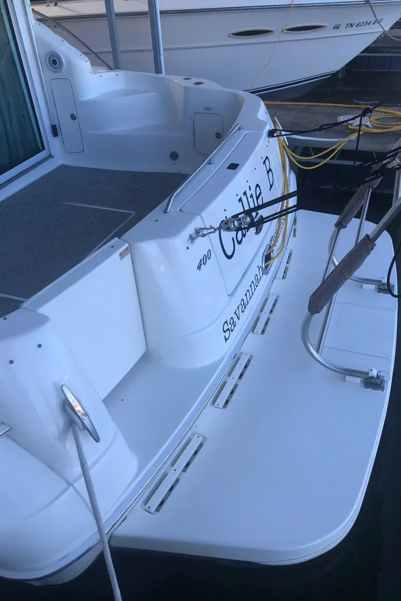Slide: The Image of 2001 Sea Ray 400 Sedan Bridge yacht docked, rear view with name "Callie B". - 9