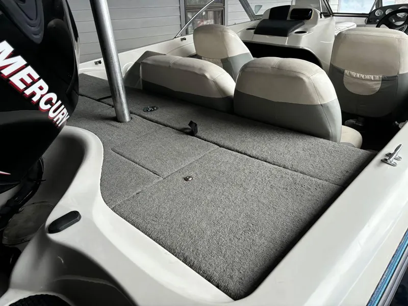 Slide: The Image of 2007 Nitro 189 Sport boat interior with Mercury engine, gray seating, and carpeted deck. - 10