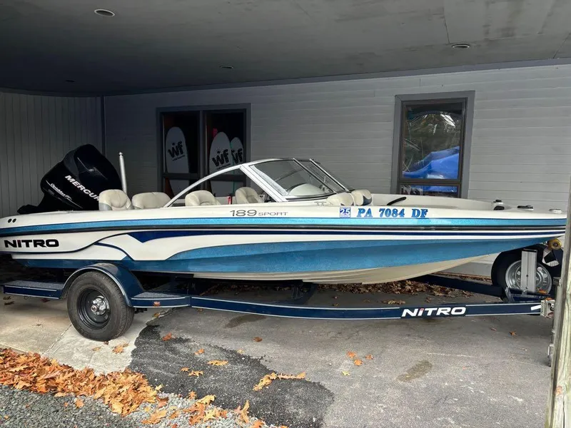 Slide: The Image of 2007 Nitro 189 Sport boat with trailer, parked under a shelter. - 4