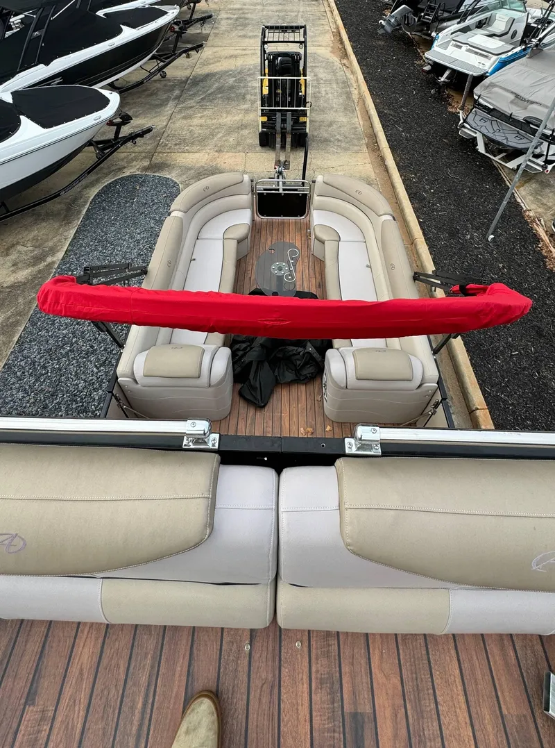 Slide: The Image of 2015 Avalon 2785 Paradise pontoon boat with beige seating and red cover, docked. - 11