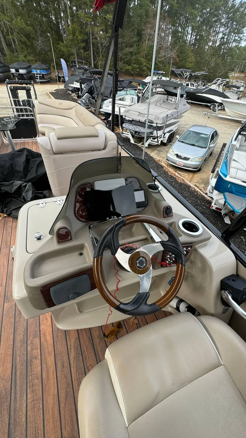 Slide: The Image of Helm of 2015 Avalon 2785 Paradise pontoon boat with steering wheel and controls. - 12