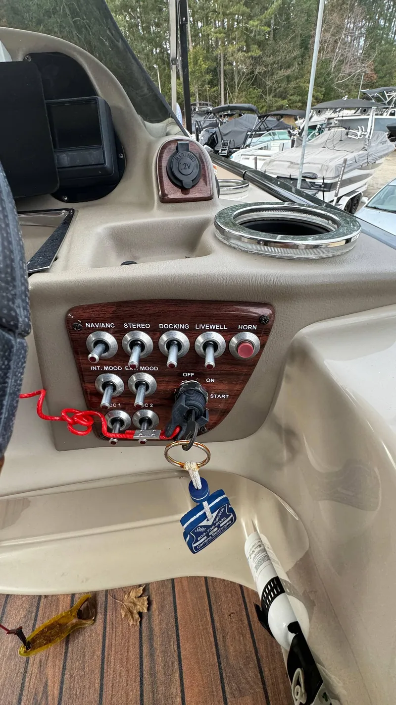 Slide: The Image of Control panel of a 2015 Avalon 2785 Paradise boat with various switches and keys. - 18