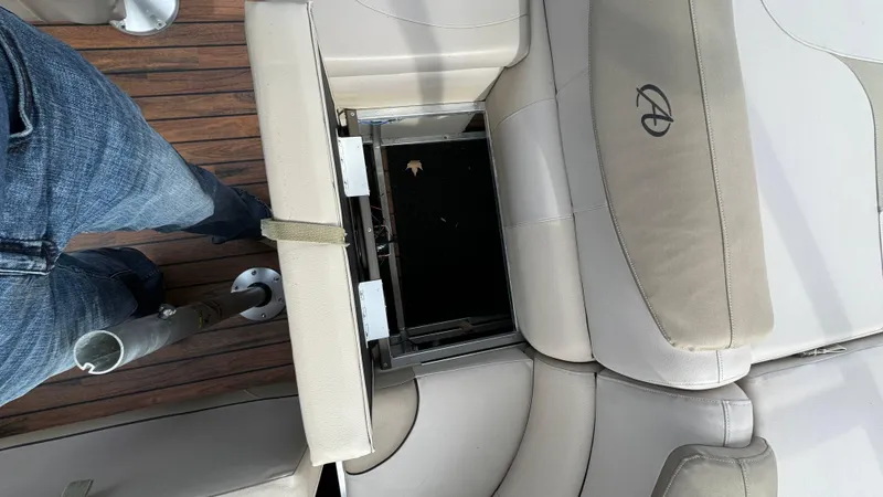 Slide: The Image of 2015 Avalon 2785 Paradise boat interior with open storage compartment and wooden flooring. - 22