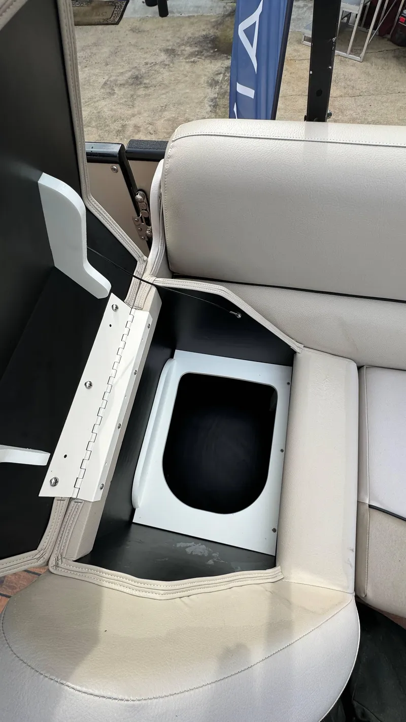 Slide: The Image of Avalon 2785 Paradise 2015 boat seat storage compartment open, revealing interior space. - 24