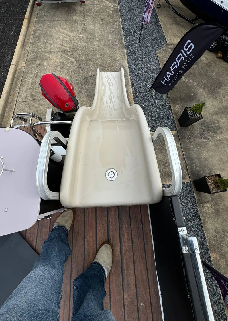 Slide: The Image of Avalon 2785 Paradise boat slide, 2015 model, with wooden deck and nearby Harris flag. - 25