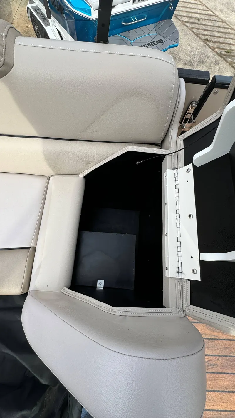 Slide: The Image of Open storage compartment in 2015 Avalon 2785 Paradise boat with beige seating. - 32