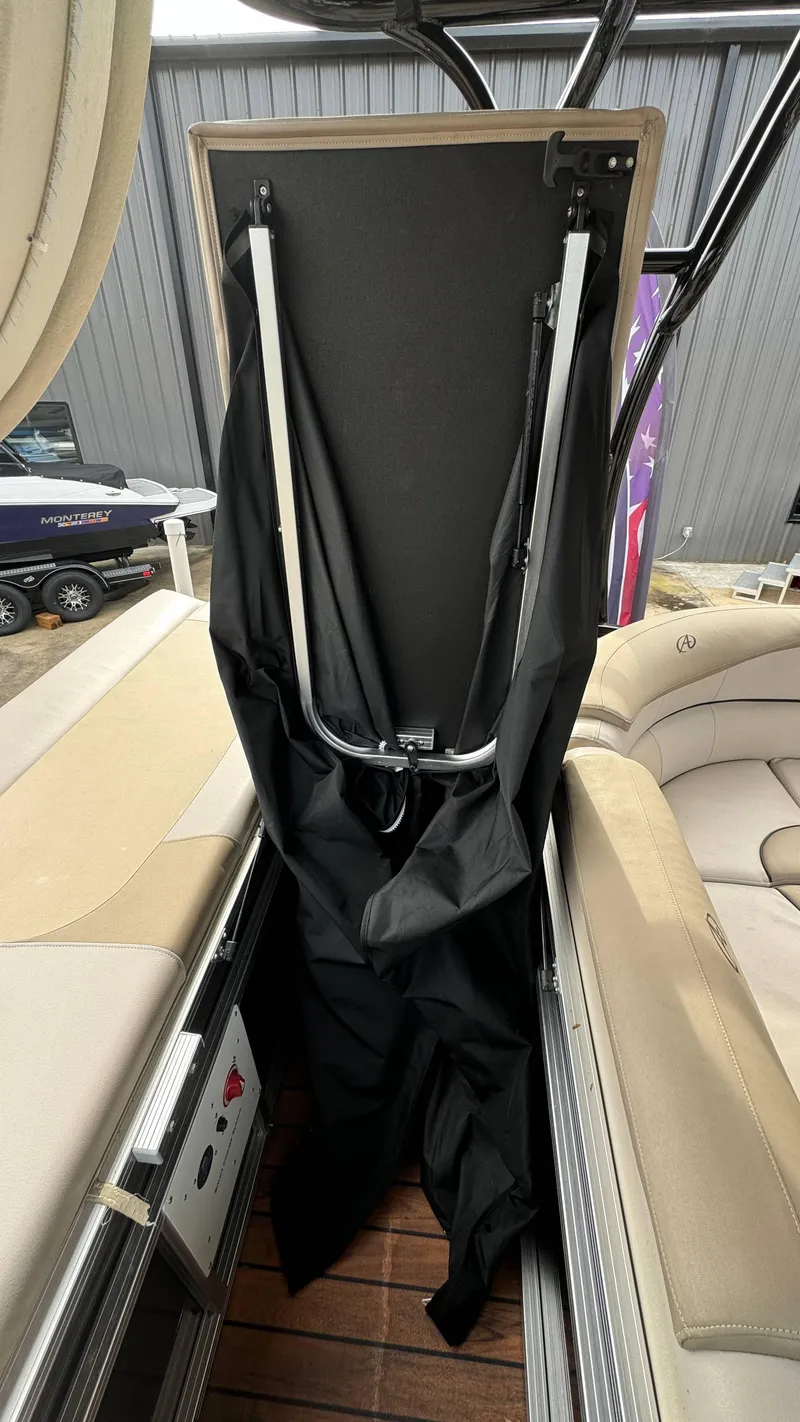 Slide: The Image of 2015 Avalon 2785 Paradise boat interior with folded canopy and seating. - 40