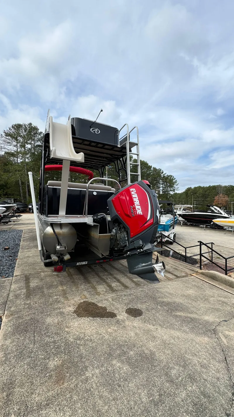 Slide: The Image of 2015 Avalon 2785 Paradise pontoon boat with Evinrude motor on a concrete dock. - 5