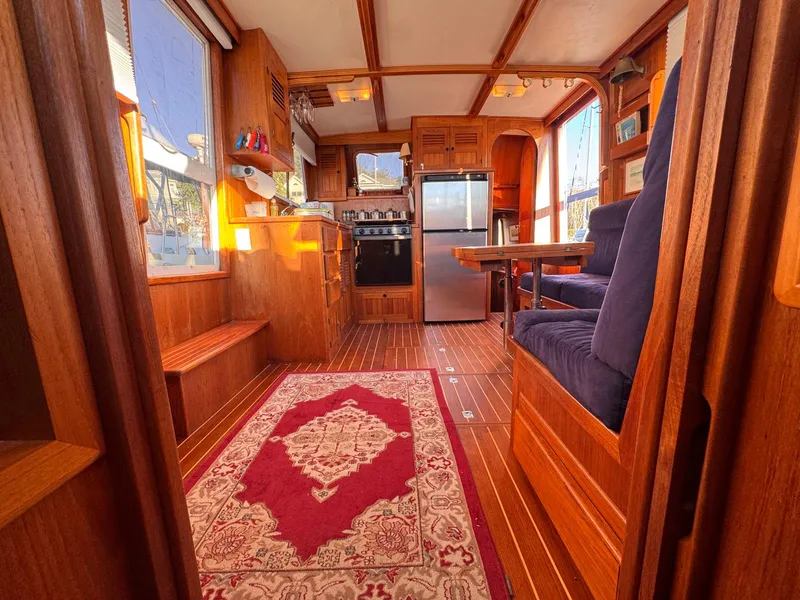 Slide: The Image of Interior of 1999 Monk 36 Trawler with wood finish, kitchen, and dining area. - 19