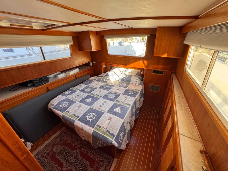 Slide: The Image of Cozy cabin interior of 1999 Monk 36 Trawler with nautical-themed bedding. - 26