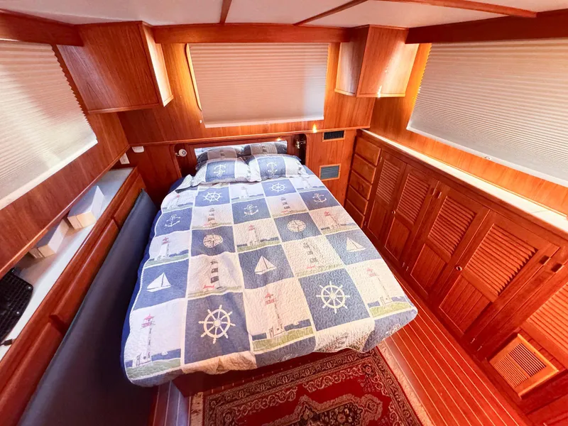 Slide: The Image of Cozy cabin interior of 1999 Monk 36 Trawler with nautical-themed bedding. - 27