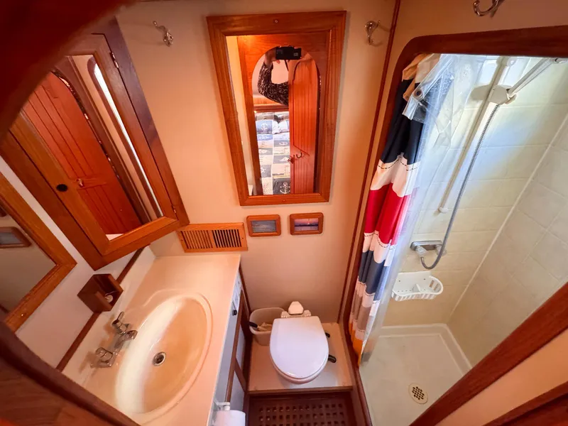 Slide: The Image of Bathroom interior of 1999 Monk 36 Trawler with shower, sink, and toilet. - 29