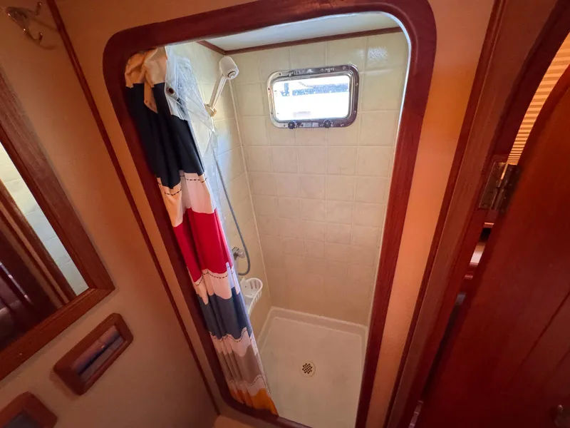 Slide: The Image of Shower area in 1999 Monk 36 Trawler with colorful curtain and small window. - 30