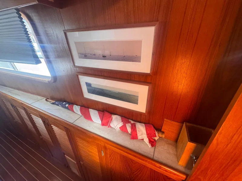 Slide: The Image of Interior of 1999 Monk 36 Trawler with framed art and folded American flag. - 35