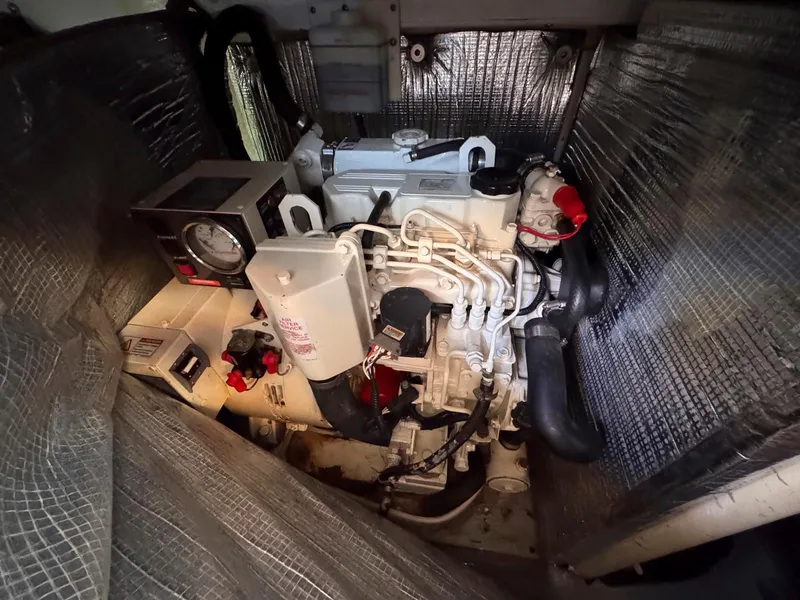 Slide: The Image of Engine room of 1999 Monk 36 Trawler with visible components and insulation. - 39