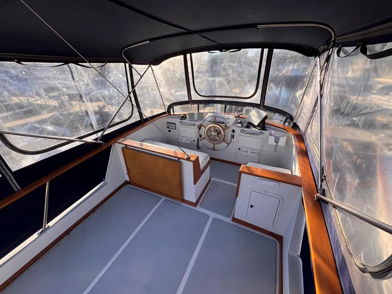 Slide: The Image of 1999 Monk 36 Trawler helm with enclosed cockpit and wooden accents. - 5