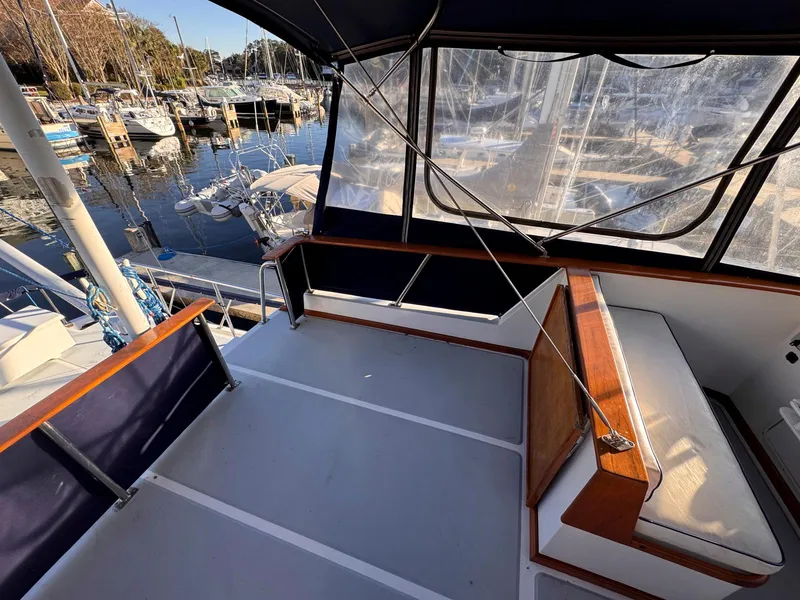 Slide: The Image of 1999 Monk 36 Trawler deck with seating, docked at marina. - 8