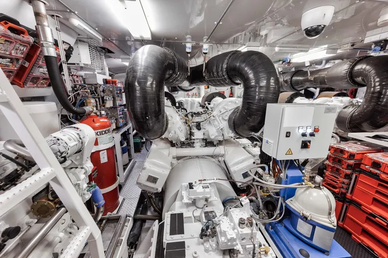 Slide: The Image of Engine room of a 2006 Palmer Johnson Express yacht, featuring complex machinery and equipment. - 41