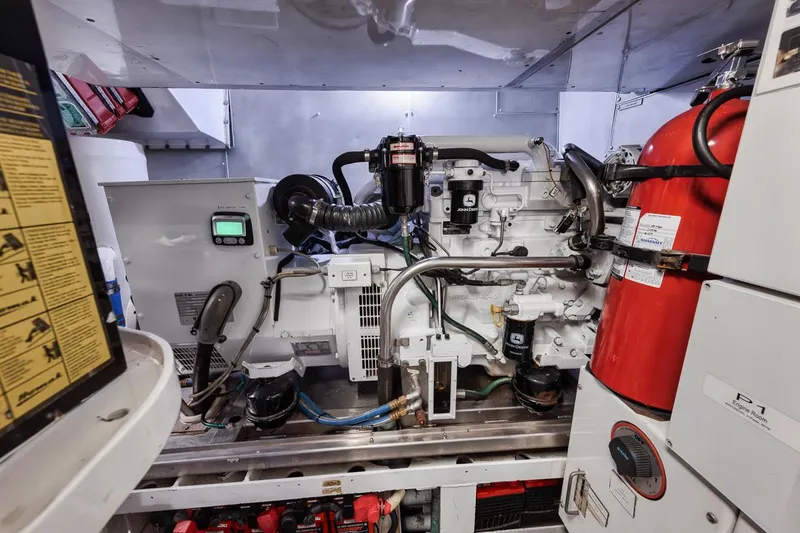 Slide: The Image of Engine room of a 2006 Palmer Johnson Express yacht, featuring machinery and safety equipment. - 43