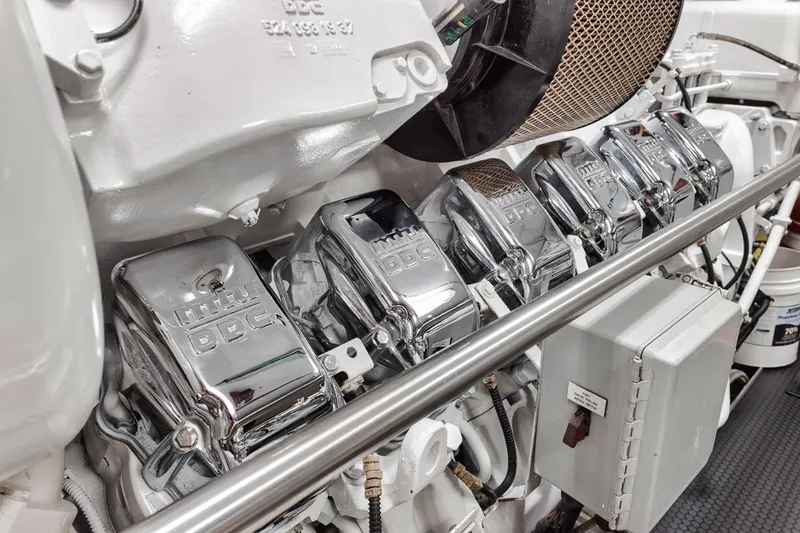 Slide: The Image of Engine components of a 2006 Palmer Johnson Express yacht, featuring chrome details and mechanical parts. - 46