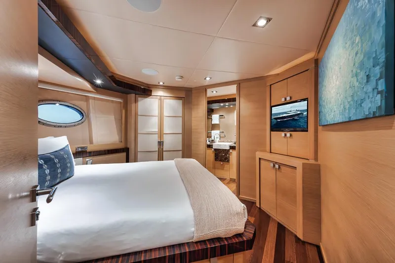 Slide: The Image of Luxurious 2006 Palmer Johnson Express yacht bedroom with modern decor and elegant wood finishes. - 49