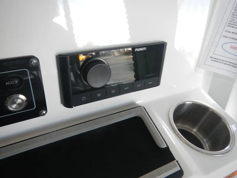 Slide: The Image of 2024 Sea Fox 228 Commander dashboard with Fusion audio system and cup holder. - 10