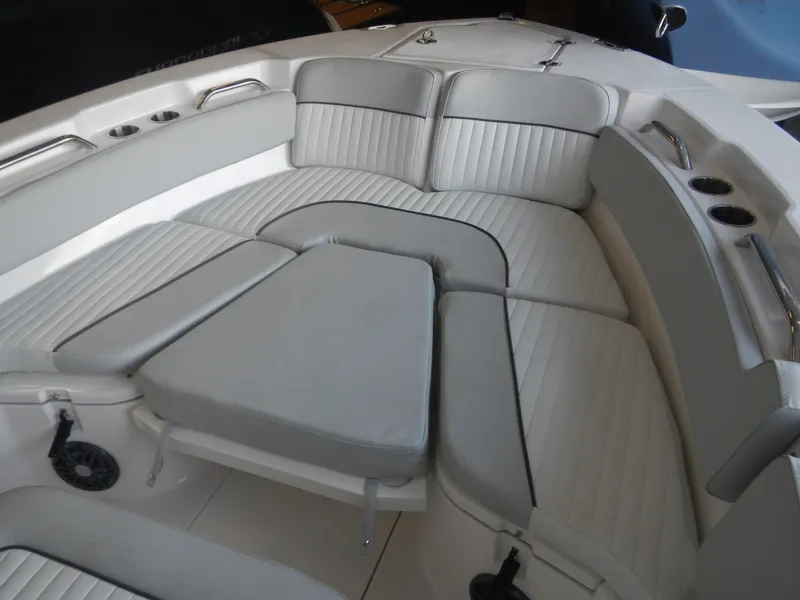 Slide: The Image of 2024 Sea Fox 228 Commander boat interior with cushioned seating and cup holders. - 14