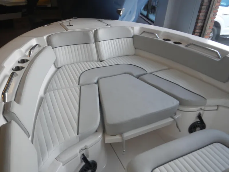 Slide: The Image of 2024 Sea Fox 228 Commander boat interior with cushioned seating and cup holders. - 4