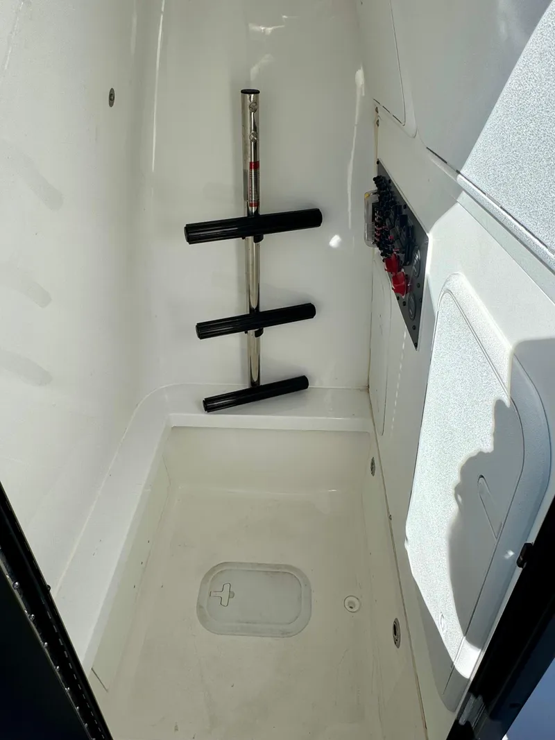 Slide: The Image of 2024 Blazer 2700 HYBRID BAY boat storage compartment with rod holders. - 14