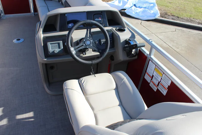 Slide: The Image of 2025 Sun Tracker Party Barge 22 DLX helm with steering wheel and controls. - 12