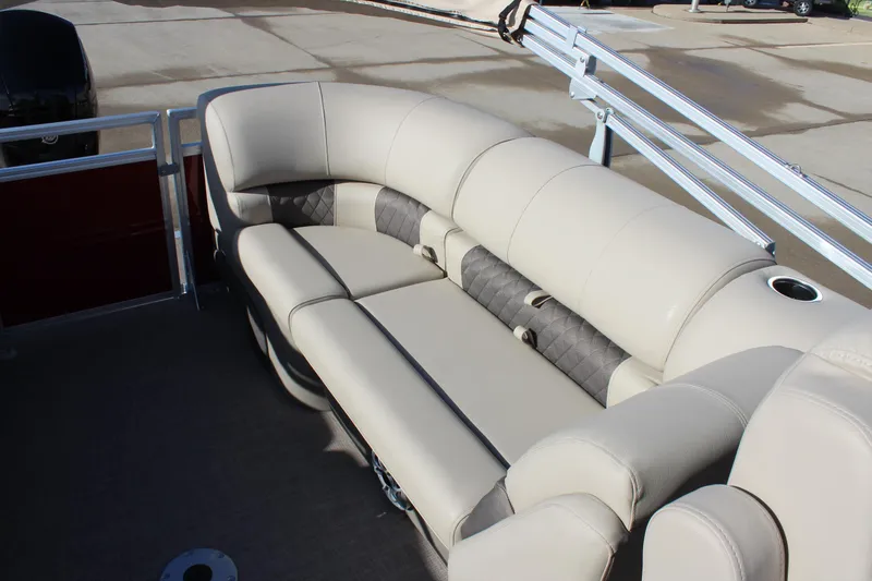 Slide: The Image of 2025 Sun Tracker Party Barge 22 DLX with beige seating and cup holders. - 14