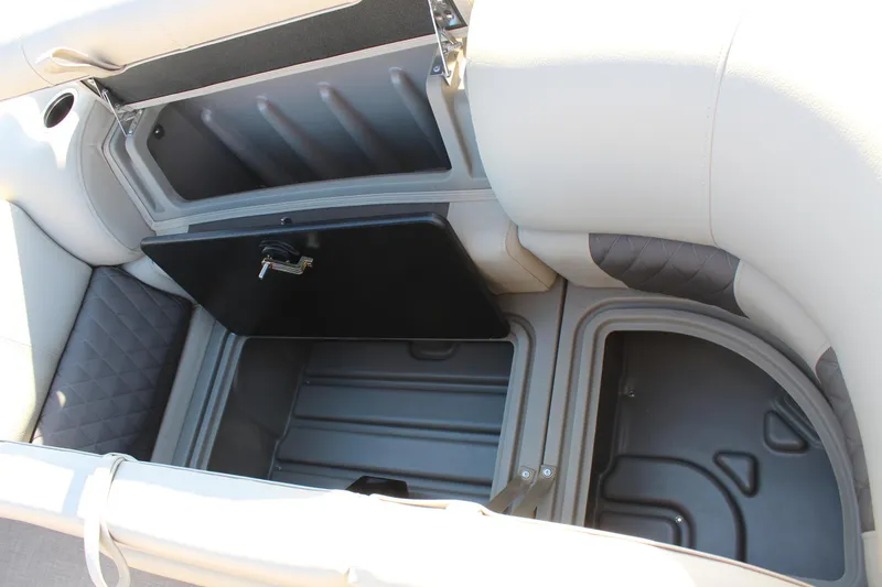 Slide: The Image of Sun Tracker Party Barge 22 DLX 2025 storage compartment with open lid. - 17