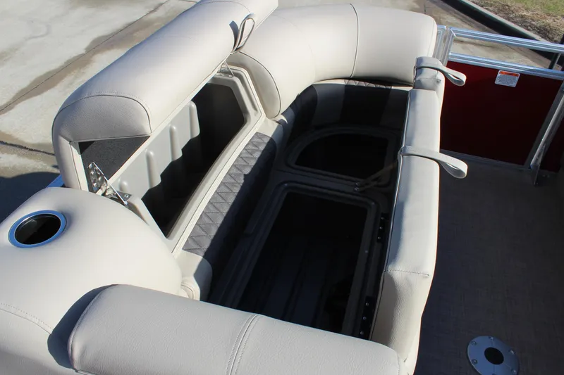 Slide: The Image of 2025 Sun Tracker Party Barge 22 DLX seating area with storage compartments. - 20