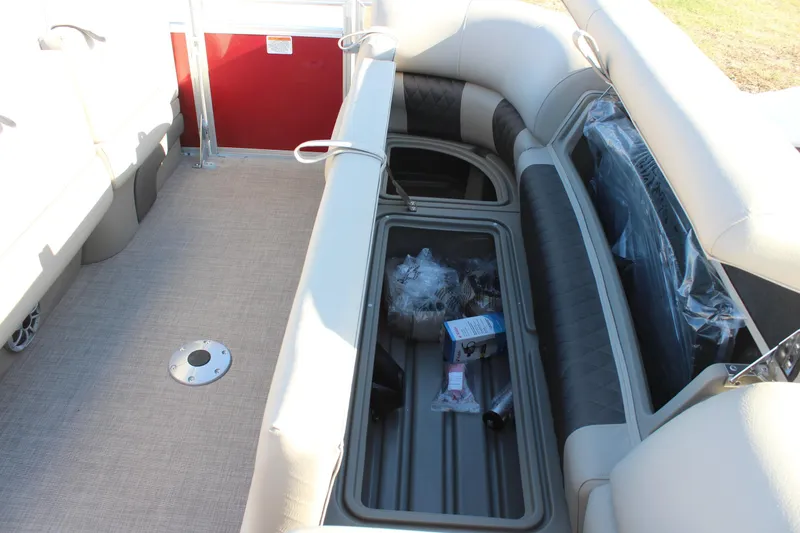 Slide: The Image of 2025 Sun Tracker Party Barge 22 DLX interior seating and storage area. - 21