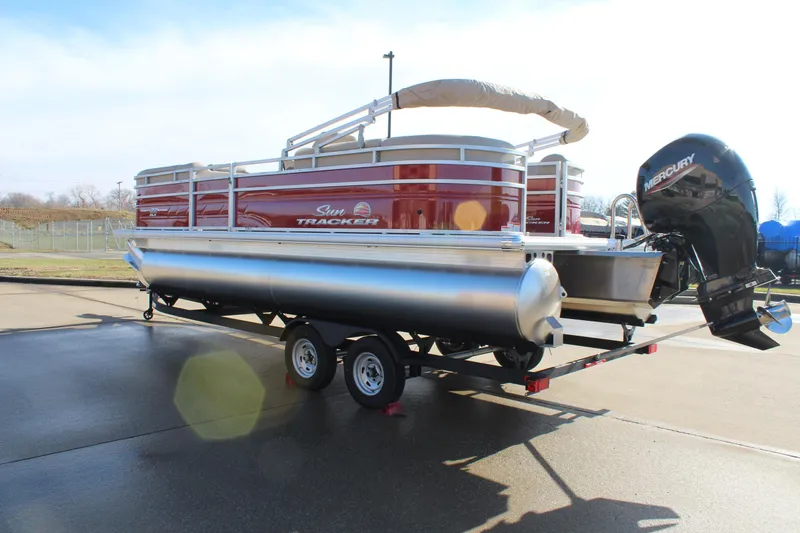 Slide: The Image of 2025 Sun Tracker Party Barge 22 DLX pontoon boat on trailer, red and silver design. - 5