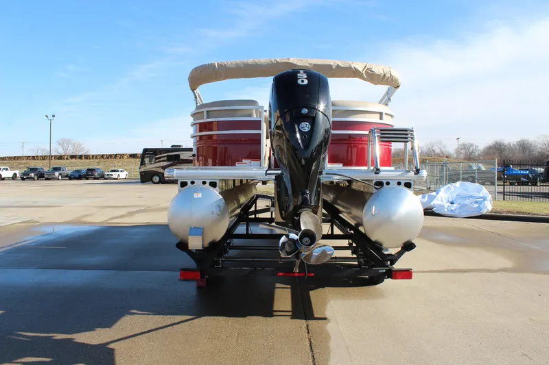 Slide: The Image of 2025 Sun Tracker Party Barge 22 DLX pontoon boat, rear view, parked on trailer. - 6
