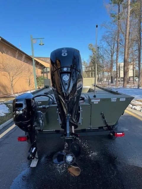 Slide: The Image of 2025 Tracker Grizzly 2072 CC Sportsman Kicker boat with powerful outboard motor. - 2