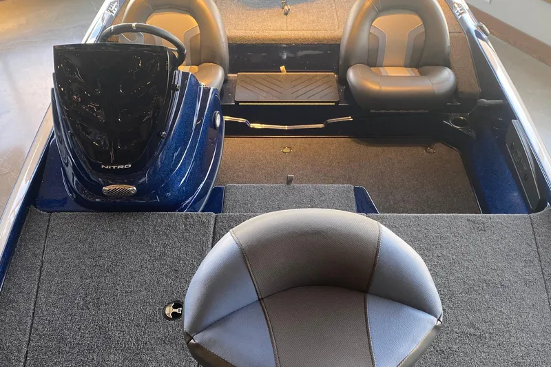 Slide: The Image of 2025 Nitro Z17 boat interior with steering wheel and seating, featuring gray upholstery. - 4